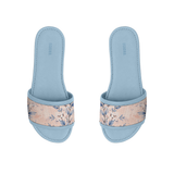 Pair of light blue ECADRA Blue Drift Slides featuring a canvas strap with a delicate white and blue botanical floral print.
