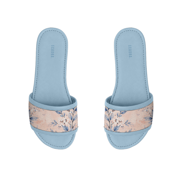 Pair of light blue ECADRA Blue Drift Slides featuring a canvas strap with a delicate white and blue botanical floral print.