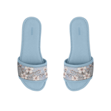 Pair of light blue ECADRA Blue Drift Slides featuring a canvas strap with a delicate white cherry blossom branch print.