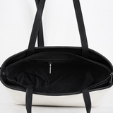 Black handbag with a white background | ECADRA