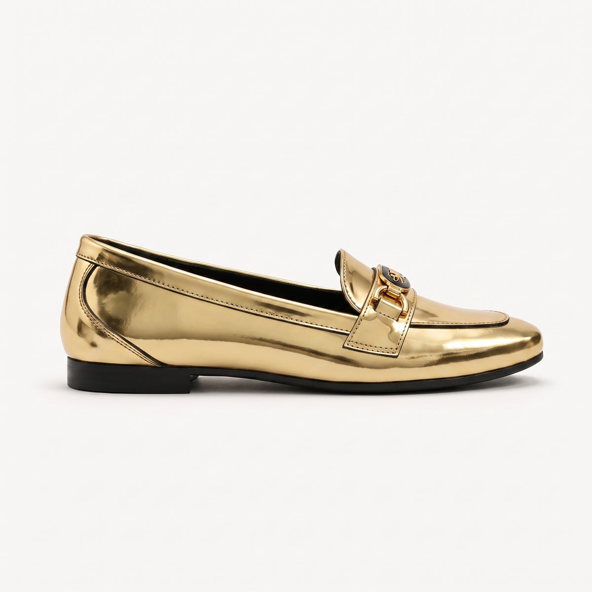 Side profile view of a metallic gold patent loafer with a black-accented buckle on a clean white backdrop.