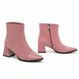 Dusty pink suede block heel booties with smooth leather cap toe on white background.