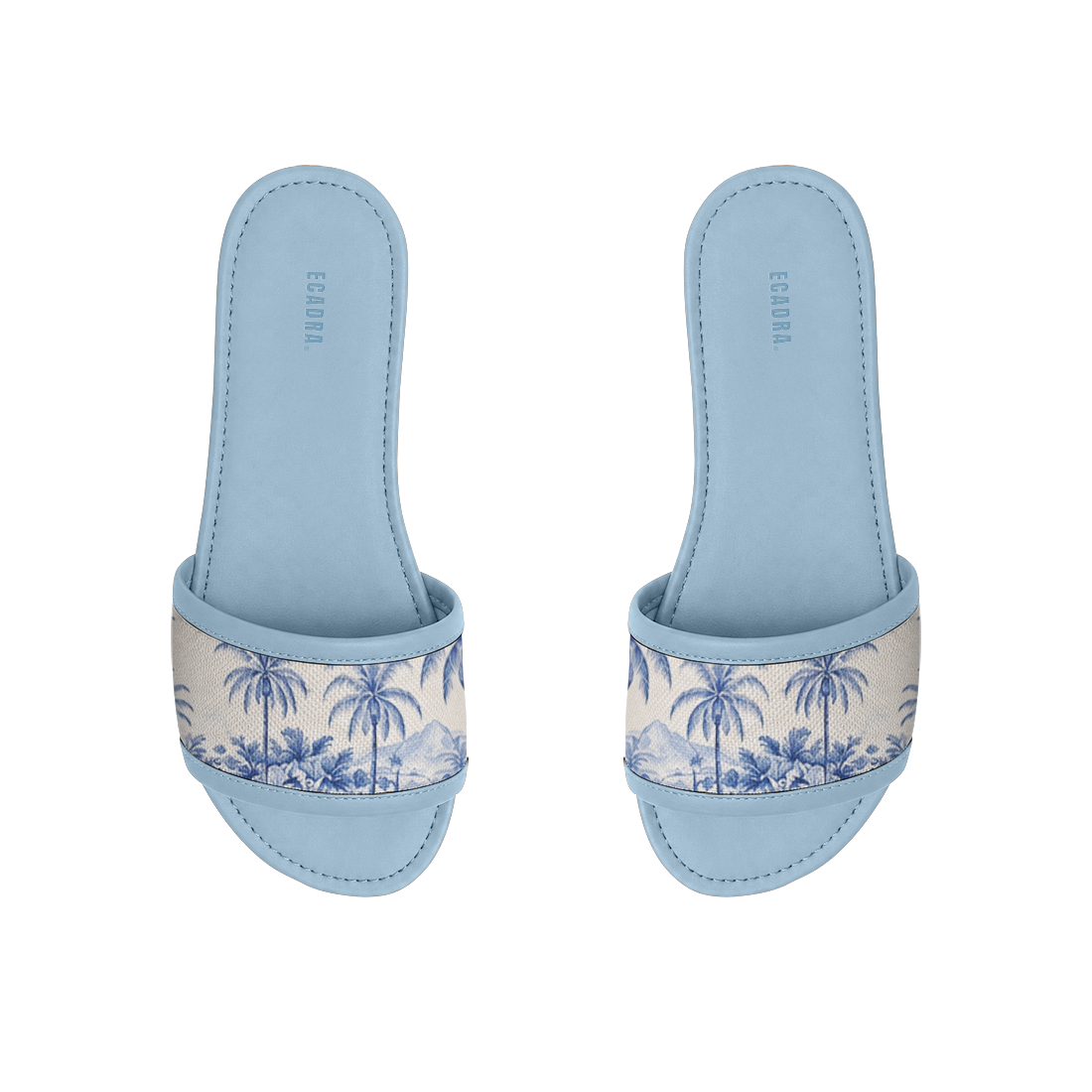 Pair of light blue ECADRA Blue Drift Slides featuring a canvas strap with a coastal blue tropical palm tree toile print.