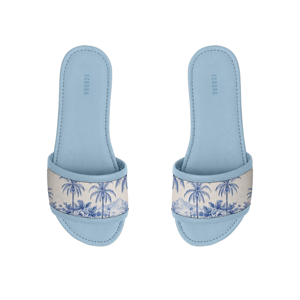 Pair of light blue ECADRA Blue Drift Slides featuring a canvas strap with a coastal blue tropical palm tree toile print.