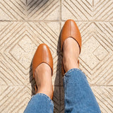 Overhead view of tan open-side Wink Flats worn with cropped jeans on tiled pavement | ECADRA