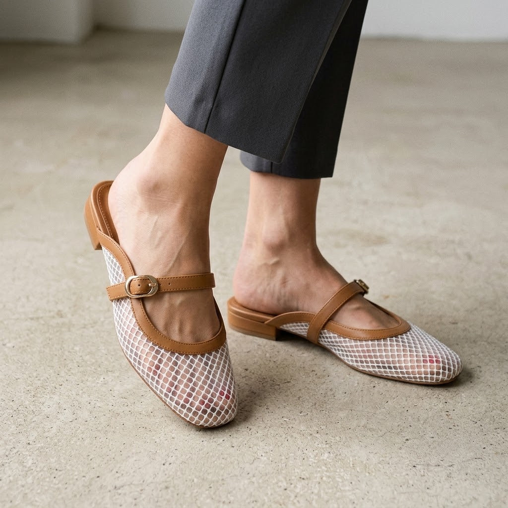Woman wearing ECADRA Mary Jane Mules featuring a breathable white mesh upper and an adjustable tan faux leather buckle strap.