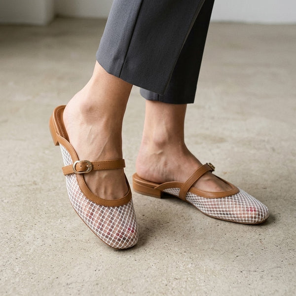 Woman wearing ECADRA Mary Jane Mules featuring a breathable white mesh upper and an adjustable tan faux leather buckle strap.