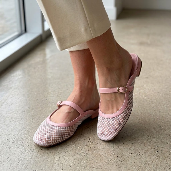 Woman wearing light pink ECADRA Mary Jane Mules featuring a breathable white mesh upper and an adjustable buckle strap.