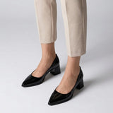 Woman wearing black gloss pointed pumps with low 5 cm flared block heel, front view — ECADRA