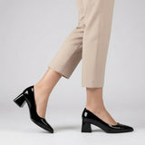 Woman walking in black gloss pointed pumps with low 5 cm flared block heel, side view — ECADRA