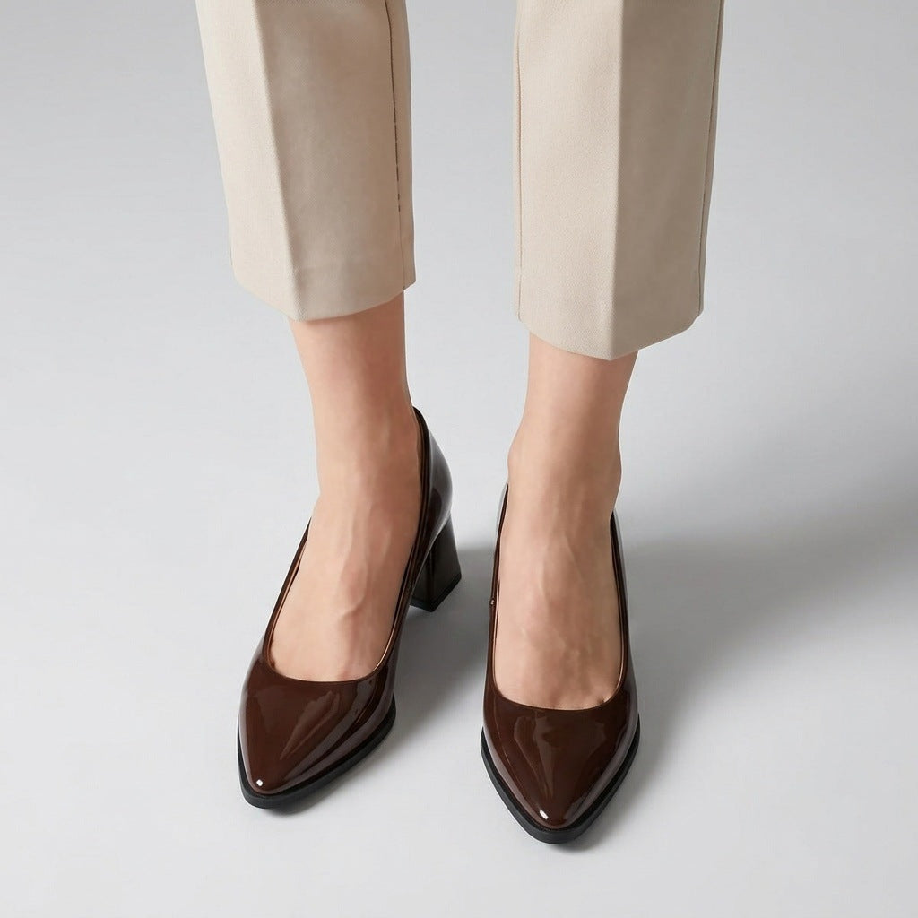 Woman wearing brown gloss pointed pumps with low 5 cm flared block heel, front view — ECADRA
