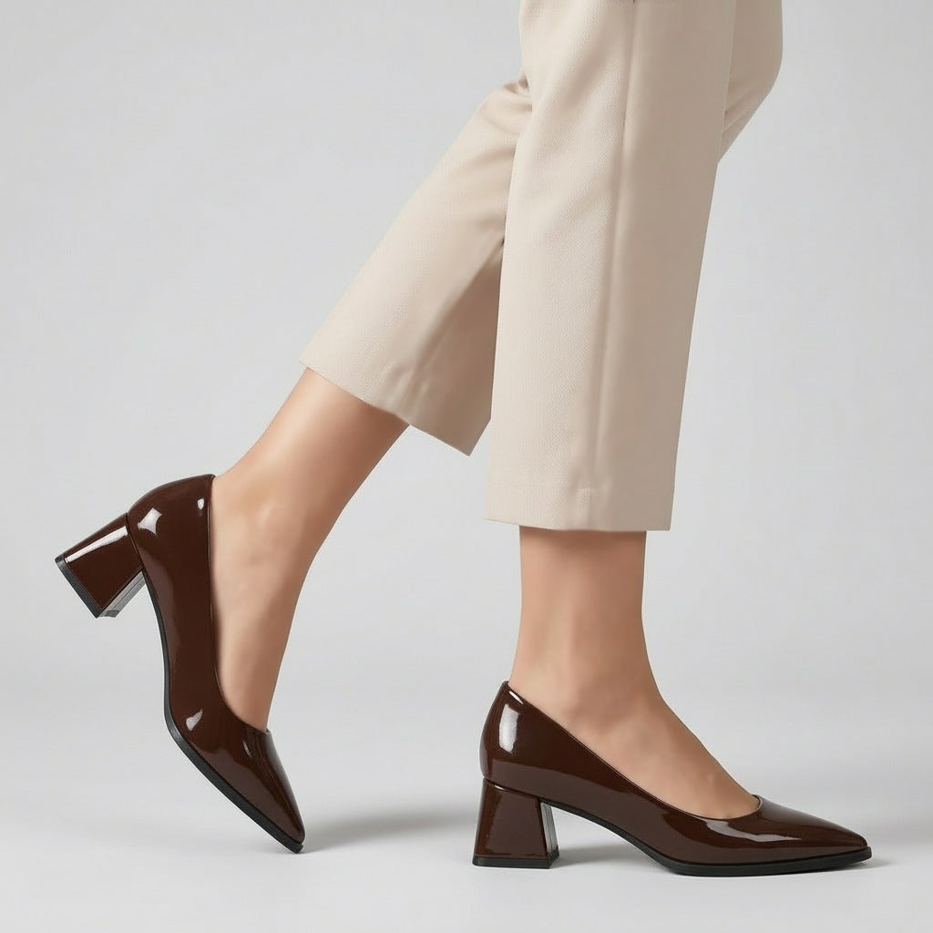 Woman walking in brown gloss pointed pumps with low 5 cm flared block heel, side view — ECADRA