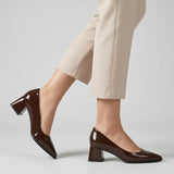 Woman walking in brown gloss pointed pumps with low 5 cm flared block heel, side view — ECADRA