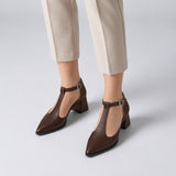 Brown matte T-strap heels with wide strap, silver buckle and 5 cm flared heel, worn on model, front — ECADRA