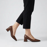 Woman walking in brown matte pointed pumps with low 5 cm flared block heel, side view — ECADRA