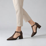 Brown matte T-strap heels with wide strap, silver buckle and 5 cm flared heel, worn on model, walking — ECADRA