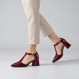 Burgundy gloss T-strap heels with wide strap, silver buckle and 5 cm flared heel, worn on model, walking — ECADRA