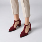 Burgundy suede T-strap heels with wide strap, silver buckle and 5 cm flared heel, worn on model, front — ECADRA