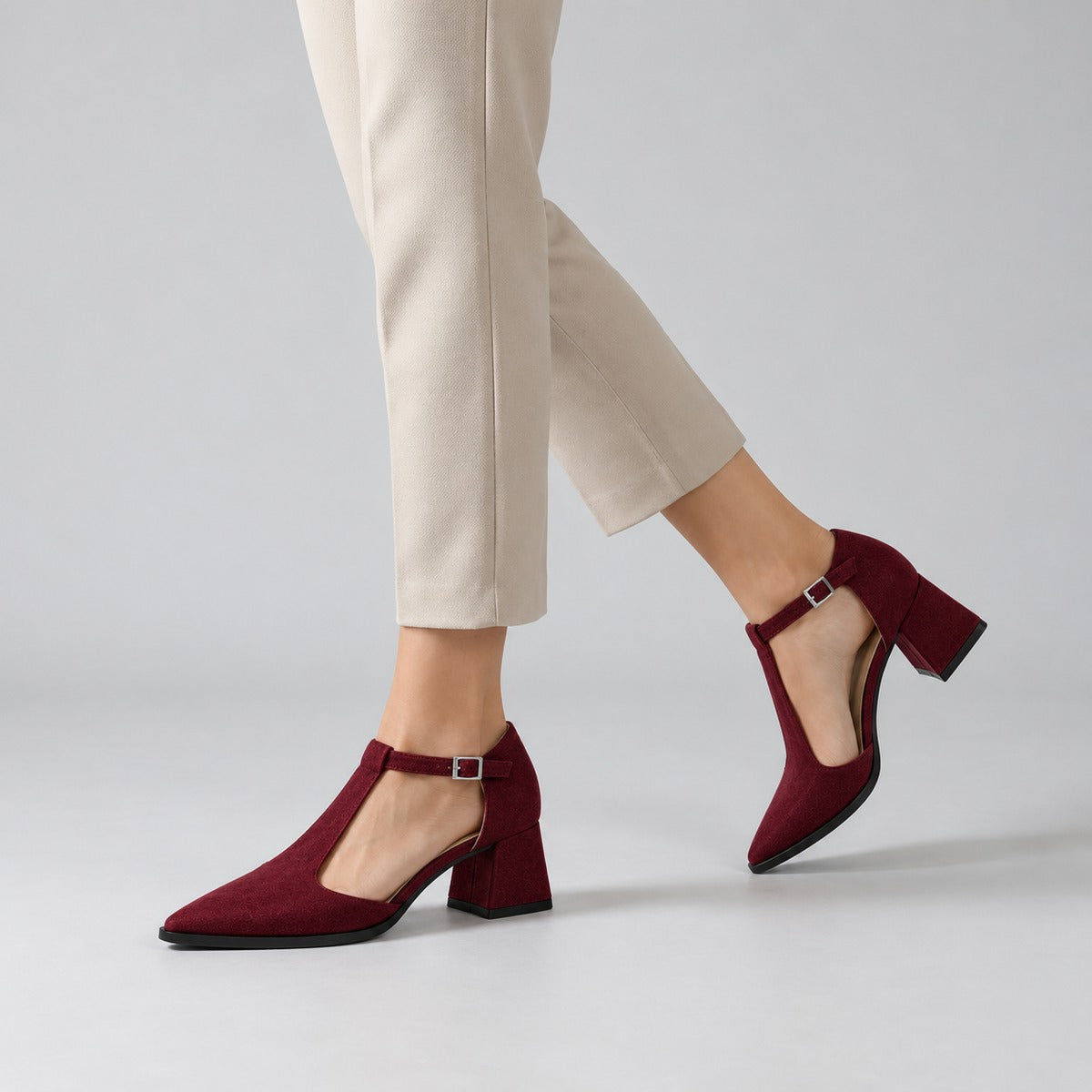 Burgundy suede T-strap heels with wide strap, silver buckle and 5 cm flared heel, worn on model, walking — ECADRA