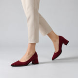 Burgundy suede pointed pump with low 5 cm flared block heel, worn on model, walking — ECADRA