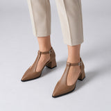 Café matte T-strap heels with wide strap, silver buckle and 5 cm flared heel, worn on model, front — ECADRA
