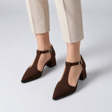 Chocolate suede T-strap heels with wide strap, silver buckle and 5 cm flared heel, worn on model, front — ECADRA