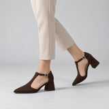 Chocolate suede T-strap heels with wide strap, silver buckle and 5 cm flared heel, worn on model, walking — ECADRA