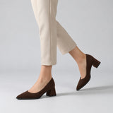 Chocolate suede pointed pump with low 5 cm flared block heel, worn on model, walking — ECADRA