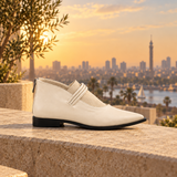Cream pointed-toe ankle boots with three coiled straps — three-quarter view — ECADRA