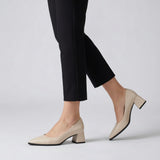 Woman walking in cream matte pointed pumps with low 5 cm flared block heel, side view — ECADRA
