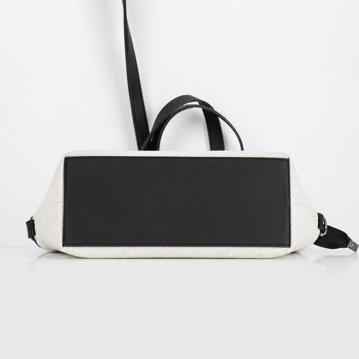 Black and white bag with a strap on a light gray background | ECADRA
