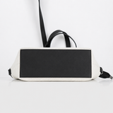 Black and white bag with a strap on a light gray background | ECADRA