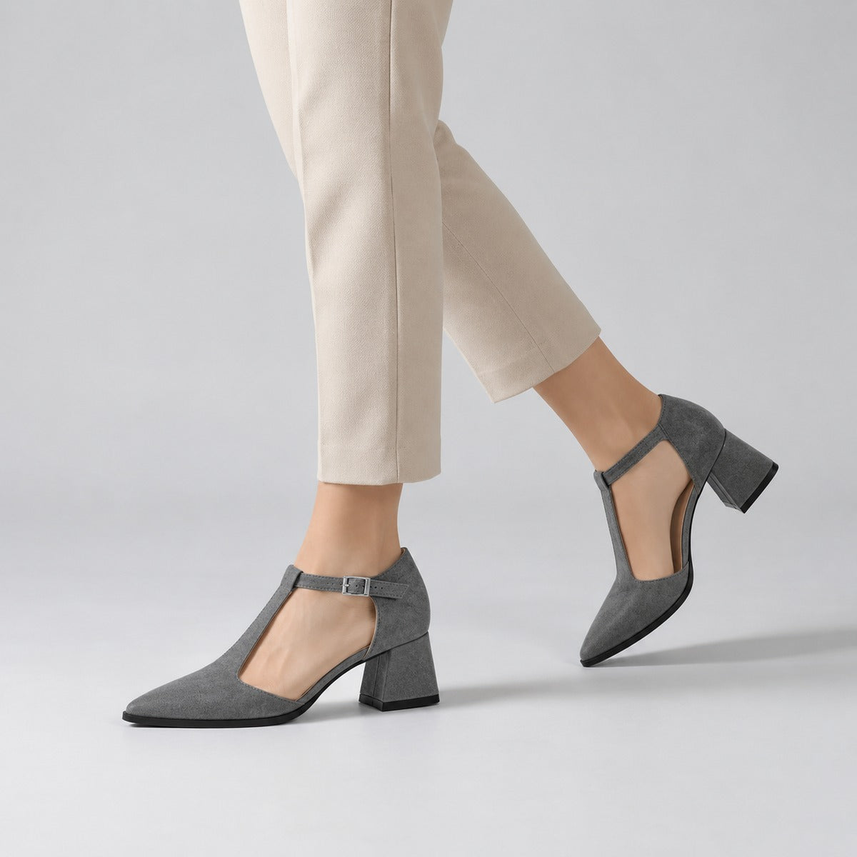 Gray suede T-strap heels with wide strap, silver buckle and 5 cm flared heel, worn on model, walking — ECADRA