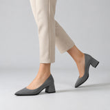 Gray suede pointed pump with low 5 cm flared block heel, worn on model, walking — ECADRA