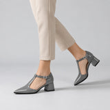 Grey gloss T-strap heels with wide strap, silver buckle and 5 cm flared heel, worn on model, walking — ECADRA