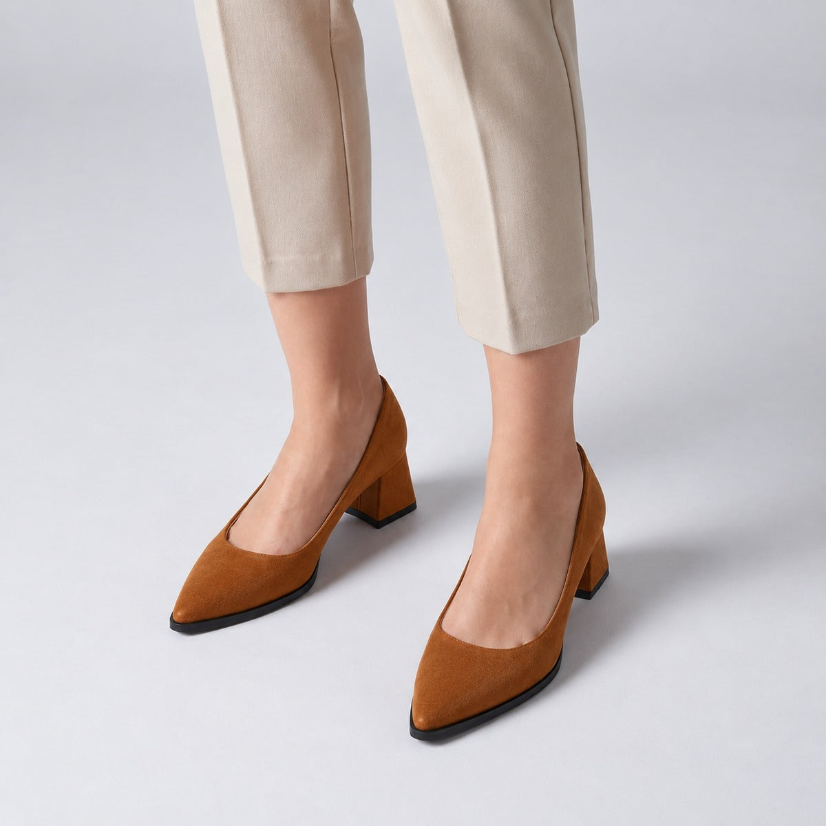 Havana suede pointed pump with low 5 cm flared block heel, worn on model, front — ECADRA