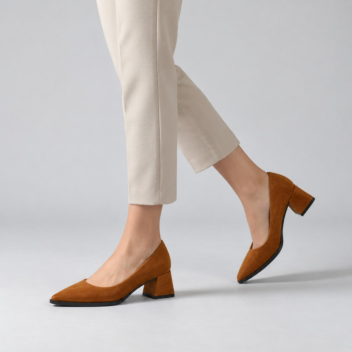 Havana suede pointed pump with low 5 cm flared block heel, worn on model, walking — ECADRA