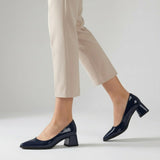 Woman walking in navy gloss pointed pumps with low 5 cm flared block heel, side view — ECADRA