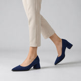 Navy suede pointed pump with low 5 cm flared block heel, worn on model, walking — ECADRA