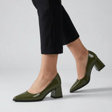 Woman walking in olive gloss pointed pumps with low 5 cm flared block heel, side view — ECADRA
