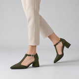 Olive suede T-strap heels with wide strap, silver buckle and 5 cm flared heel, worn on model, walking — ECADRA