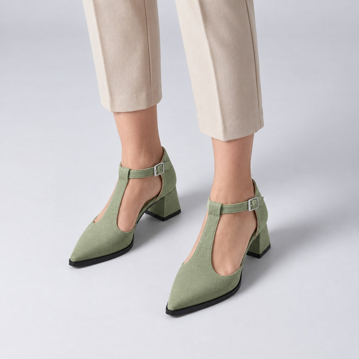 Pistachio suede T-strap heels with wide strap, silver buckle and 5 cm flared heel, worn on model, front — ECADRA