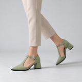 Pistachio suede T-strap heels with wide strap, silver buckle and 5 cm flared heel, worn on model, walking — ECADRA