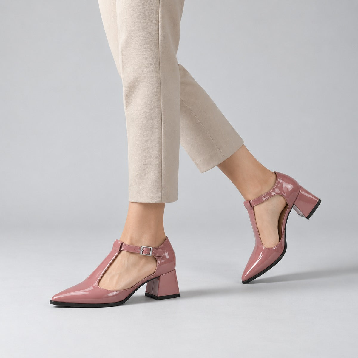 Rose gloss T-strap heels with wide strap, silver buckle and 5 cm flared heel, worn on model, walking — ECADRA