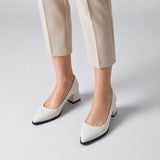 White suede pointed pump with low 5 cm flared block heel, worn on model, front — ECADRA