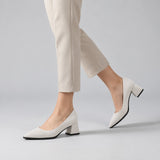 White suede pointed pump with low 5 cm flared block heel, worn on model, walking — ECADRA